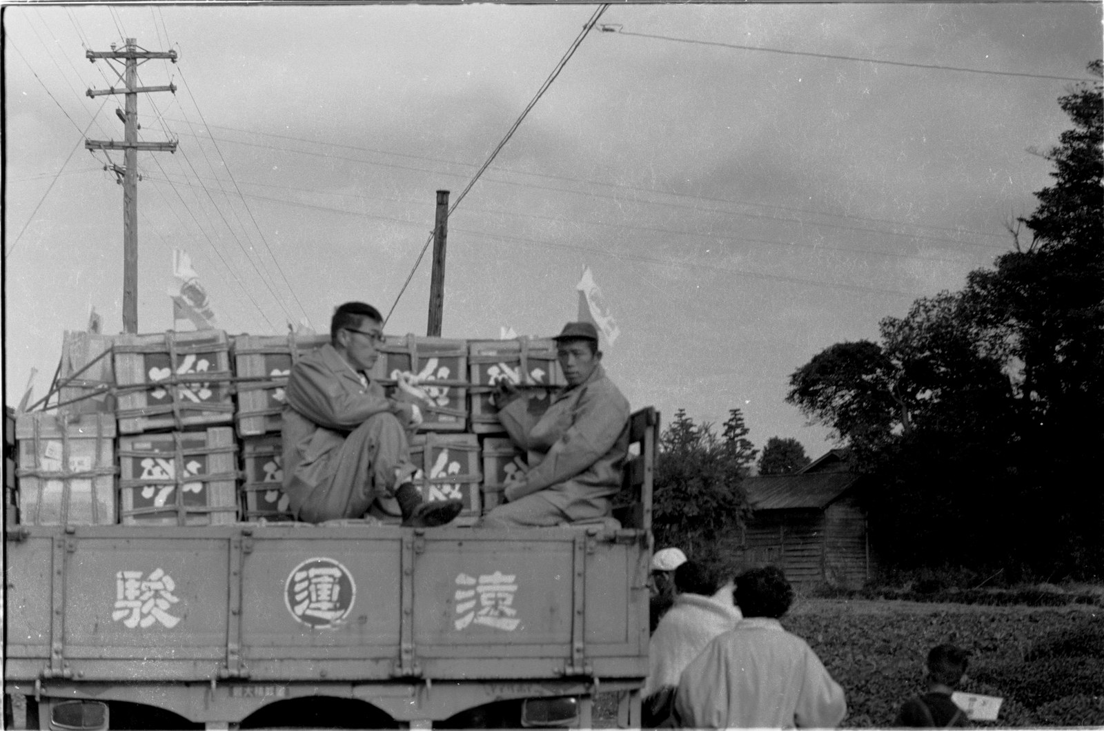 Hatsuni drivers aboard their loaded trucks, 1963